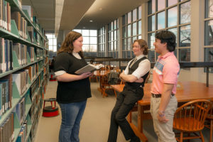 Three students in a library